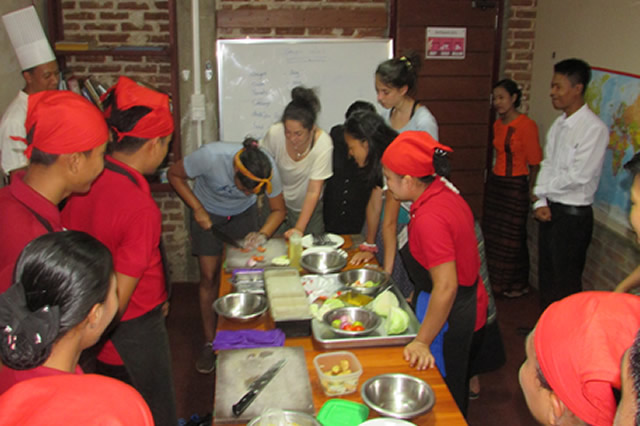 Students from the USA taking a turn to practice kitchen skills